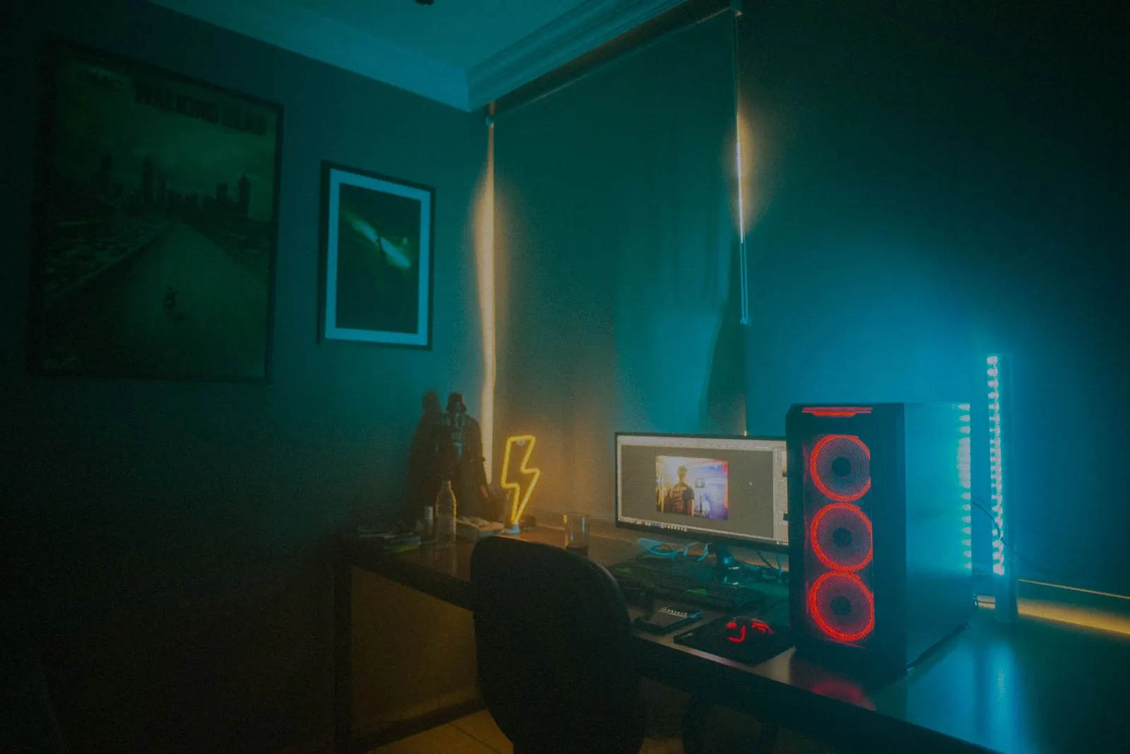 A gaming PC with red fans in a dimly lit room